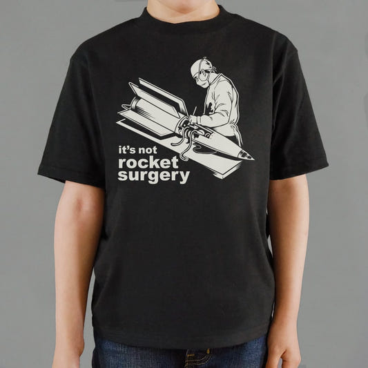 It's Not Rocket Surgery Surgeon Operating on a Rocket graphic Kids T-Shirt in Black